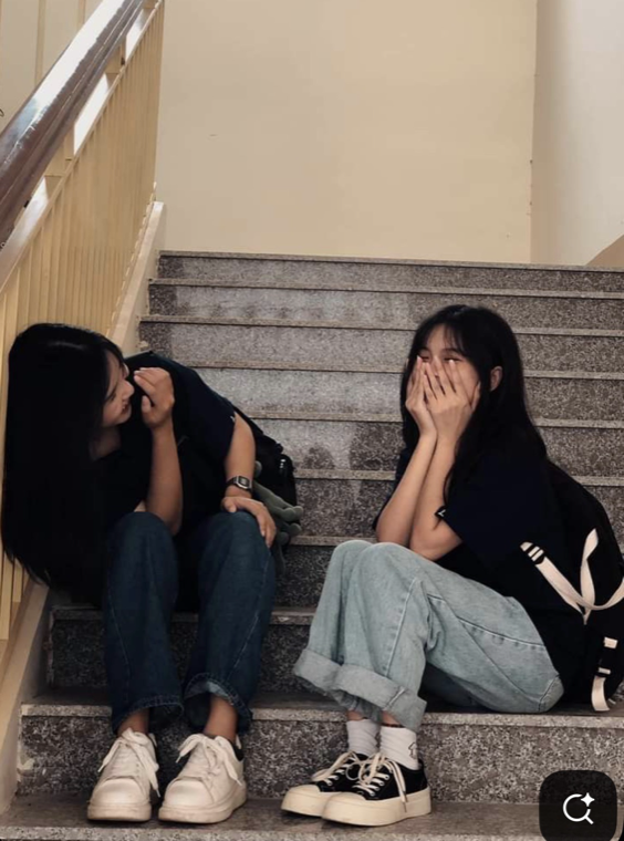 The original photo of two people sitting on a staircase with a gap between them.