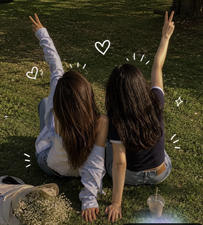 Two people sitting close together with their backs to the camera.